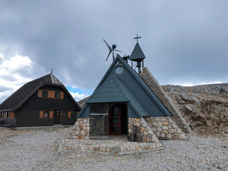 Chapel of Maria snowy standing beside cottage at mountain Kredarica at 2515m.