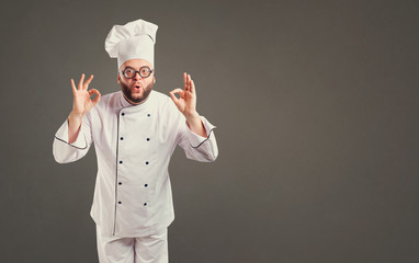 Funny cheerful chef in white uniform on background for text.