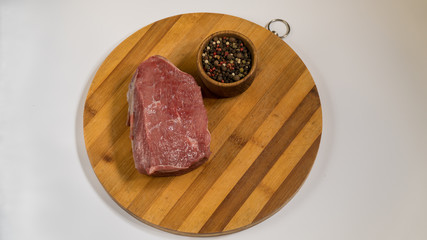meat on a wooden board. spices and beef.