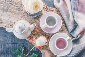 Pure coffee or tea set. A pair of elegant porcelain light gray and pastel pink cups on a cozy background