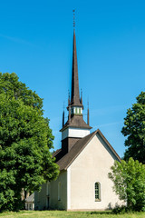 White church with tall and narrow tower