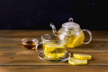 Glass Cup and Glass Teapot with Hot and Tasty Lemon and Ginger Tea Hot Autum Winter Drink Horizontal Copy Space