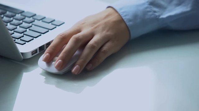 Lefthanded using wireless mouse with laptop, modern personal computer technology