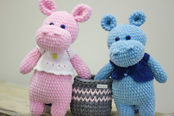 Cute handmade crochet hippopotamus on white background. Toy knitted hippos.