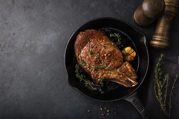Zelfklevend Fotobehang beef steak on cast iron pan, dark background © anna_shepulova