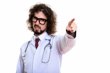 Studio shot of angry man doctor pointing finger at distance