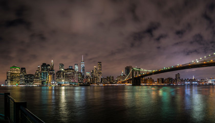 Fototapeta na wymiar New York City Manhattan downtown panorama at night with skyscrapers illuminated over east river