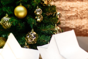 Shiny gold and silver christmas balls on white with pine tree
