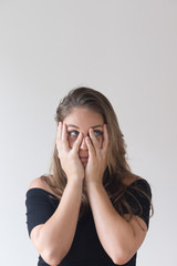 Upset pretty Caucasian girl covering face and looking aside. Portrait of young female manager...