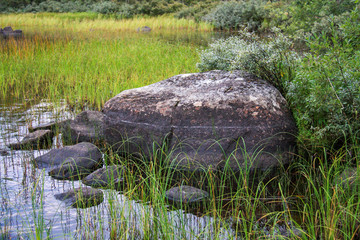 Big stone on the lake shore in Karelia