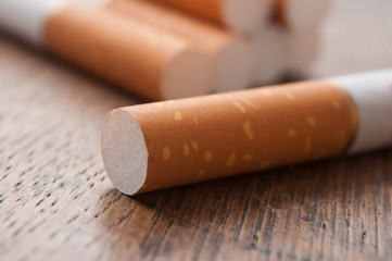 closeup of cigarettes on wooden table background