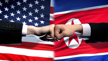 US vs North Korea conflict, international relations, fists on flag background