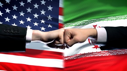 US vs Iran conflict, international relations crisis, fists on flag background