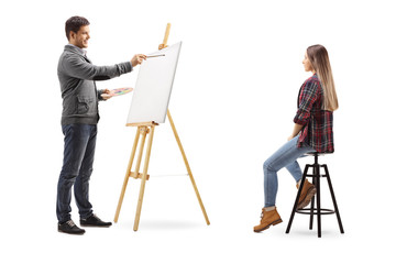 Naklejka premium Young man painting a female on a canvas