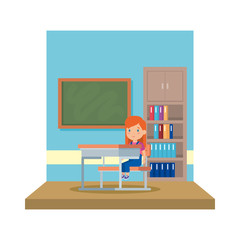 little schoolgirl sitting in schoolchair in the classroom