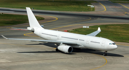 Modern passenger civil airplane taxiing at international airport