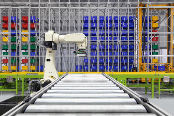 Robotic arm loading plastic crates on pallet. empty rollers steel for transport conveyor turning of...