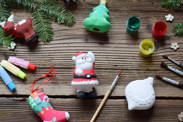 Painting Christmas toys from porcelain for decorations. Making clay toy with your own hands. Children's DIY concept. Handmade crafts on holiday. Master class of art