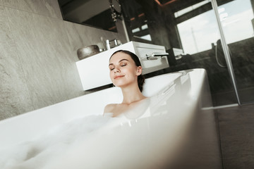 Concept of water enjoyment and relaxation at home. Close up portrait of beautiful woman with...