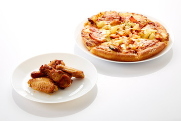 Pizza and fried chickens are white plate