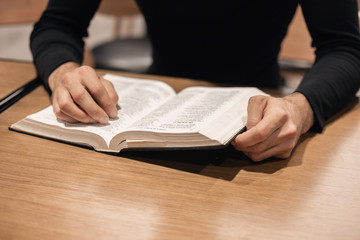 Modern man reads a book, close up photo