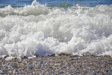 pebble beach on the black sea. the wave in the background.