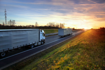 Truck transport on the road at sunset - obrazy, fototapety, plakaty