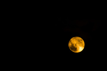 yellow moon on black night sky background