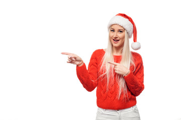 Christmas  woman in Santa hat is showing to the left blank empty billboard. Space for text, sale