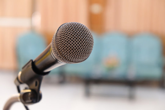 Close up head of microphone on stage of business meeting or event