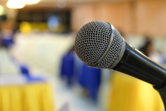Close up head of microphone on stage of business meeting or event