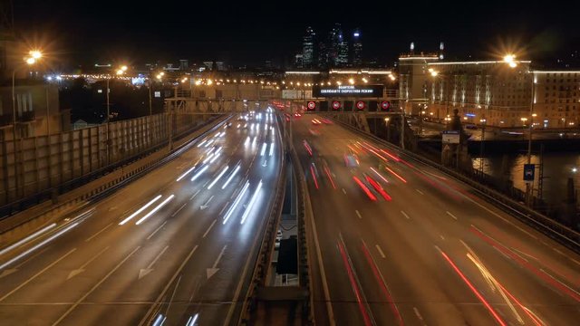 Timelapse.Night city traffic on the highway. Speed Limit Signs