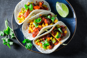 Top view of tacos with meat and tomato sauce