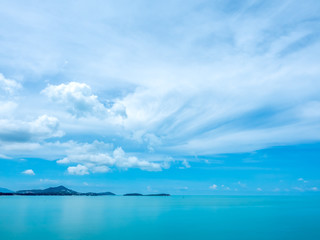 Naklejka na ściany i meble Seascape view under cloudy blue sky
