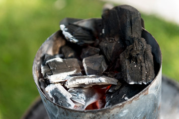 Burning charcoal in barbecue chimney