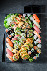 Healthy sushi mix with shrimps and rice on concrete table