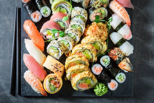 Sushi mix made of salmon and avocado on concrete table