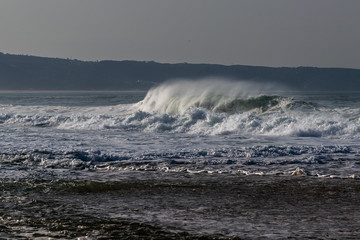 Naklejka na ściany i meble Atlantic ocean wave next to Nazare, Portugal.