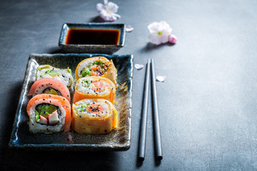 Sushi mix with vegetables and seafood on concrete table