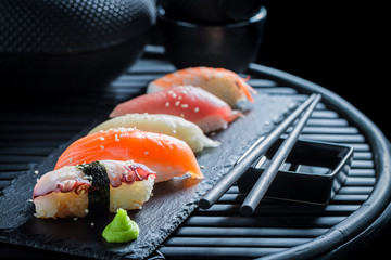 Delicious Nigiri sushi with rice and shrimp on dark table © shaiith