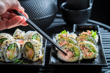 Tasting sushi mix with wasabi and soy sauce