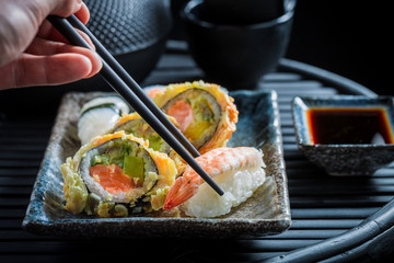 Closeup of tasting sushi set with shrimps and rice