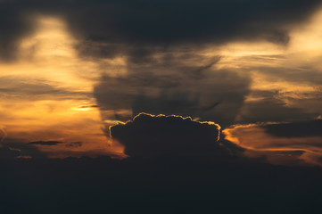 The sun goes down behind a large cloud, giving a beautiful light and shadow, looking like a crown....