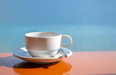 Empty coffee cup at sea side view
