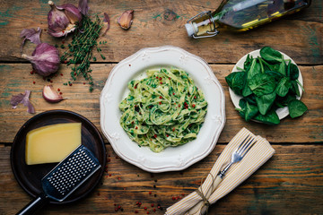 Spinach Fettuccine. Vegan pasta with spinach (Spinach Fettuccine Alfredo Pasta) on a white plate....