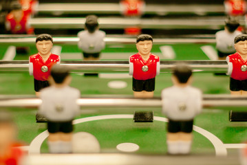 classic foosball, a fragment of the playing field with two rows of player figures close-up