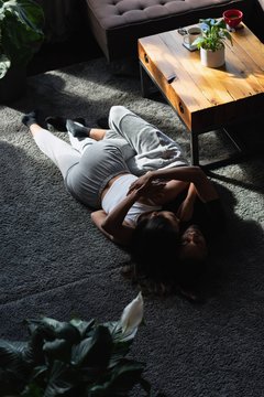 Couple sleeping on floor in living room
