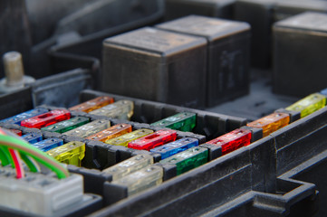 Under hood fusebox of a car with relays.