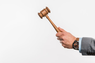 close-up partial view of male judge holding wooden hammer isolated on white