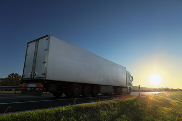 Obraz premium Truck transport on the road at sunset